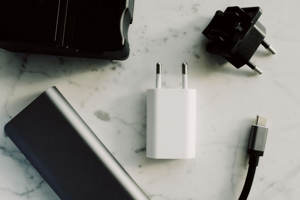 Close-up of an electronic device power adapter showing input voltage and model specifications before checking overseas compatibility.